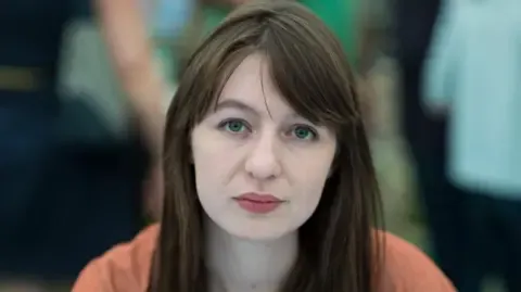 The acclaimed novelist declares she is unable to travel to the UK over potential arrest